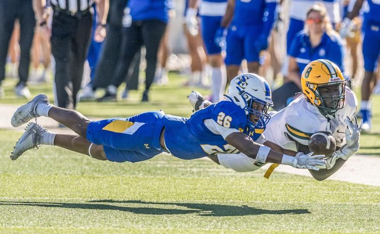 SE’s Kole McKnight and an Arkansas Tech player lunge for the ball during the game last Saturday at Paul Laird Field. Dan Hoke | SE