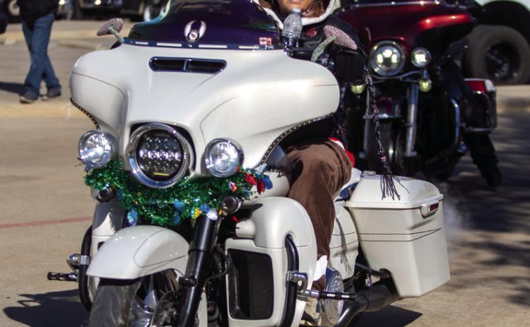 LoJo Reid rides her motorcycle during the Okie Christmas Toy Run that raised money to provide toys to children for Christmas. Matt Swearengin | Durant Democrat