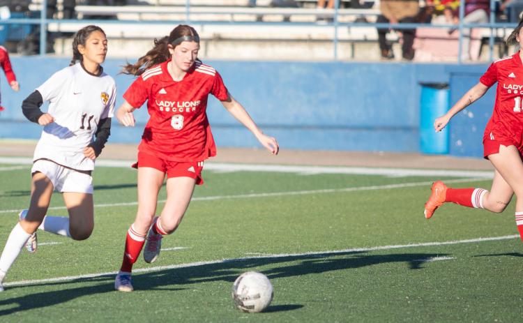 Lady Lion soccer players Addison Polk, Kendi House and Karah Boydstun are shown in last week’s game with the Madill Lady Wildcats. Matt Swearengin | Durant Democrat