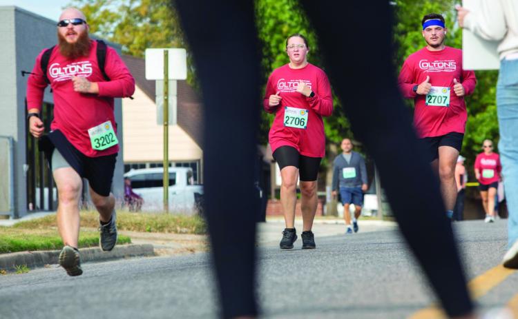 Runners are shown near the finish line during last year’s Colton’s Main Street Run. Matt Swearengin | Durant Democrat