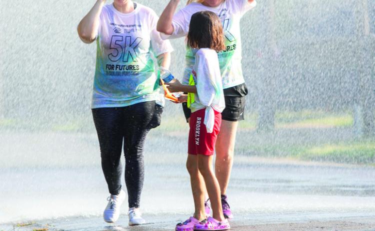 Participants in the Boys &amp; Girls Club Color Run were hosed down by the Durant Fire Department.