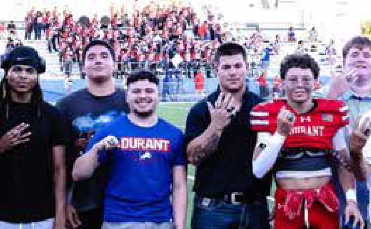 The 2026 Durant Lions boys powerlifting team was recognized for their back-to-back state championship before the start of a recent football game. From left, Conlee Tiffie, Draegen Baker, Christopher Beccera, Justin Andrus, Cruz Gomez, Jahir Ascencio, Jaxson Cuesta, Brandon Cordell, Jaston Stepp, Coach Dills, Christopher Hix and Gage Rocha. Not pictured is Stephen Manhard. Paul Steen | Boss Hogg Photography