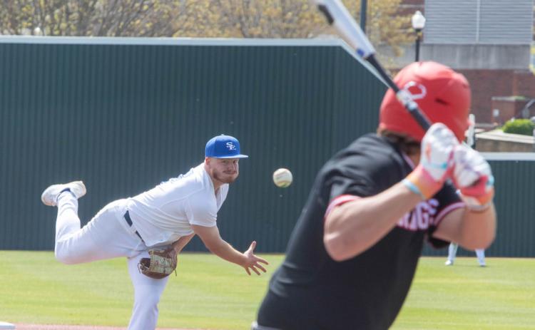 Savage Storm player Cameron Hauch hurls a pitch at a Northwestern batter. Matt Swearengin | Durant Democrat