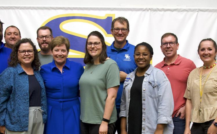 Liz McCraw and a group of former employees pose at the ceremony for the dedication of the Liz Cobb McCraw Auditorium on Saptember 23. Photo by Raymond Griffith