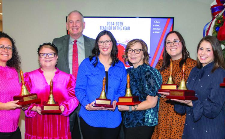 The Durant Schools Teachers of the Year for each campus were honored last week during a meeting of the Durant Board of Education. From left, Eva Burgess, REL Early Childhood Center; Natalie Cox, Washington Irving; Pamela Couch, Intermediate School; Heather Smiley, George Washington; Taylor Williams, Middle School; Kasey Bennett, Northwest Heights, and Shannon Gaines, High School. Also shown are Superintendent Mark Moring and Assistant Superintendent Kenny Chan. Matt Swearengin | Durant Democrat