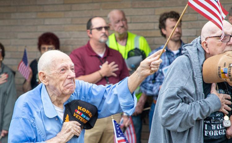 Veteran Bob Story reacts when a flag is raised at the Ron Cross Senior Activity Center on Sept. 11. WoodmenLife donated a flagpole and flag to the center. Matt Swearengin | Durant Democrat