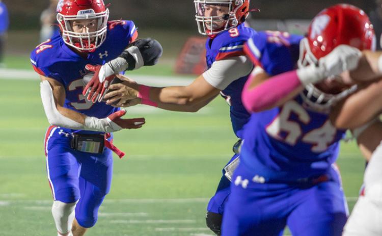 Matt Swearengin | Durant Democrat Lion Cole Robbins hands the ball to Stephen Manhard.