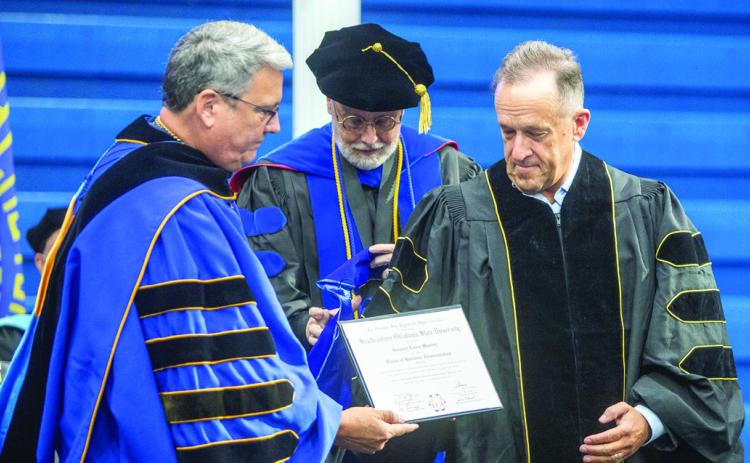 Southeastern President Dr. Thomas Newsom presented an honorary doctorate degree posthumously to John Massey and Massey’s son, Greg Massey, who is CEO of First United Bank, also received an honorary doctorate degree. Also shown is Dr. David Whitlock, who was named interim president of Southeastern e_ective Aug. 1. Newsom was named president of Pittsburg State University in Kansas. Matt Swearengin | Durant Democrat