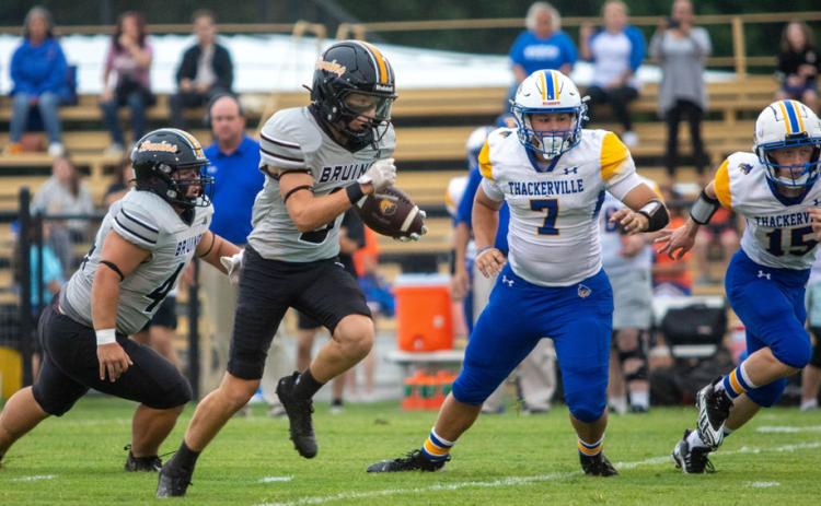 Caddo Bruin Jake McKay runs with the ball during the season opener. Also shown is Zander Nabors. Matt Swearengin | Durant Democrat