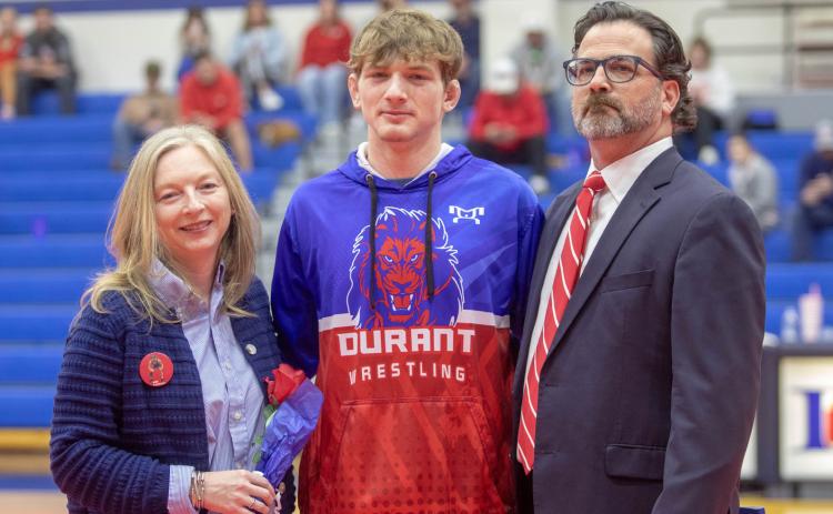 Matt Swearengin | Durant Democrat Durant Lion wrestling senior Mac Barbush was honored Feb. 3 during the home dual with Davis. He is shown with parents Amy Pierce-Barbush and John Barbush, who is an assistant coach.