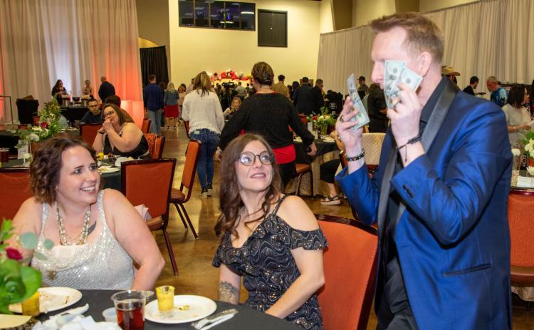 A magician provided entertainment during the Taste of Durant that was hosted by Leadership Durant. Shown are, Rina Kravitz and Shelley Dunnam. Matt Swearengin | Durant Democrat