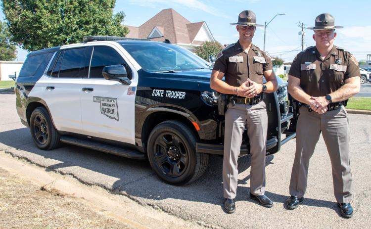 Oklahoma Highway Patrol Lt. Mark Southall, left, public information office, and Capt. Scott Hampton, commander of OHP Troop E, showed a new patrol car last week. OHP has been driving black cars and is now returning to black and white. Matt Swearengin | Durant Democrat