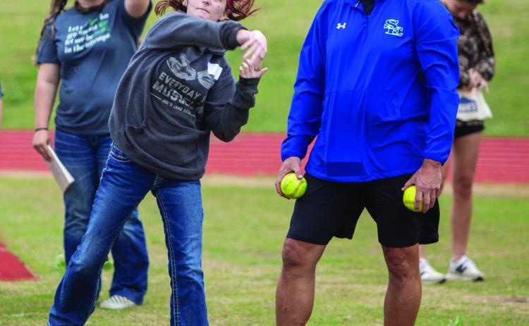 Special Olympics Oklahoma Red River Area hosted a track and field event April 1 at the Durant Multi-Sports Complex. As softball throw was among activities and shown is Southeastern head women’s basketball coach Darin Grover, who volunteered to help at the event. Matt Swearengin | Durant Democrat