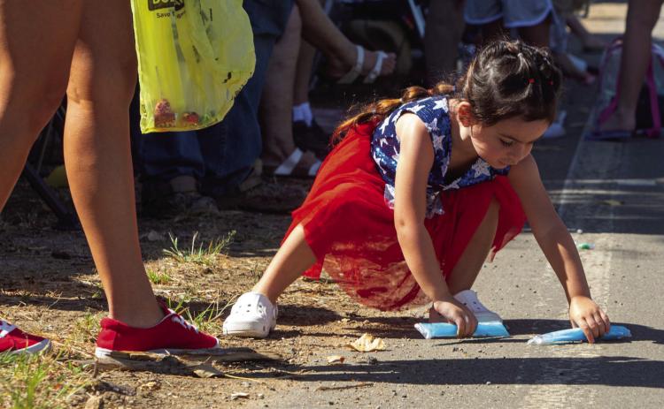 Bennington had its 62nd annual Homecoming Saturday and Marah Perry picks up candy during the parade. Matt Swearengin | Durant Democrat