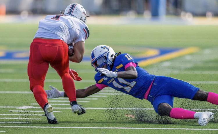 SE’s Trevion Butler lunges for a Northwestern player. Dan Hoke | SE