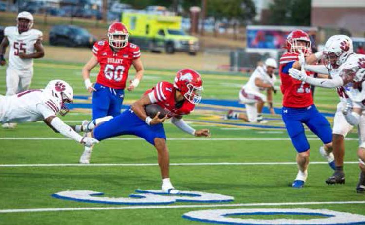 An Ardmore player lunges for Durant Lion Joseph Flores. Matt Swearengin | Durant Democrat