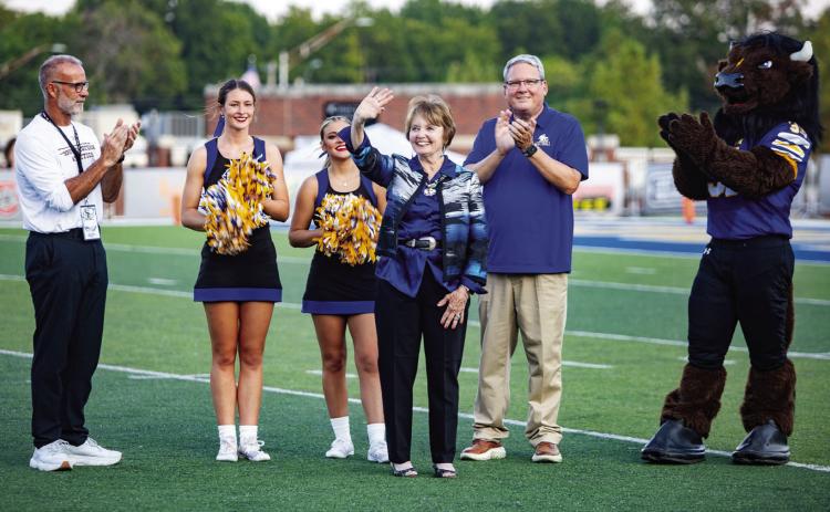 Artist Jane Semple Umsted, who is being inducted into the 2024 Oklahoma Women’s Hall of Fame, was recognized during last Saturday’s Southeastern football game. Also shown are Keith Baxter, left, director of SE Athletics, and SE President Thomas Newsom. Matt Swearengin | Durant Democrat