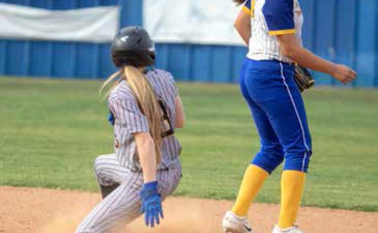 Caddo Lady Bruin Kayden Cowan slides to first base and also shown is Rock Creek Lady Mustang Mahlia Venegas. Matt Swearengin | Durant Democrat