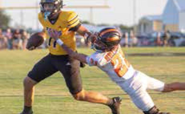 Caddo Bruin Corbin Stoner runs with the ball as Dewar Dragon Bentley Thrall attempts a tackle. Matt Swearengin | Durant Democrat