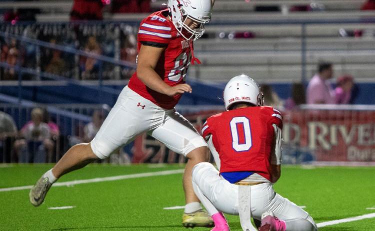 Durant Lion Otto Baskin is about to kick the extra point and holding the ball is Kacin Washington Macey. Matt Swearengin | Durant Democrat