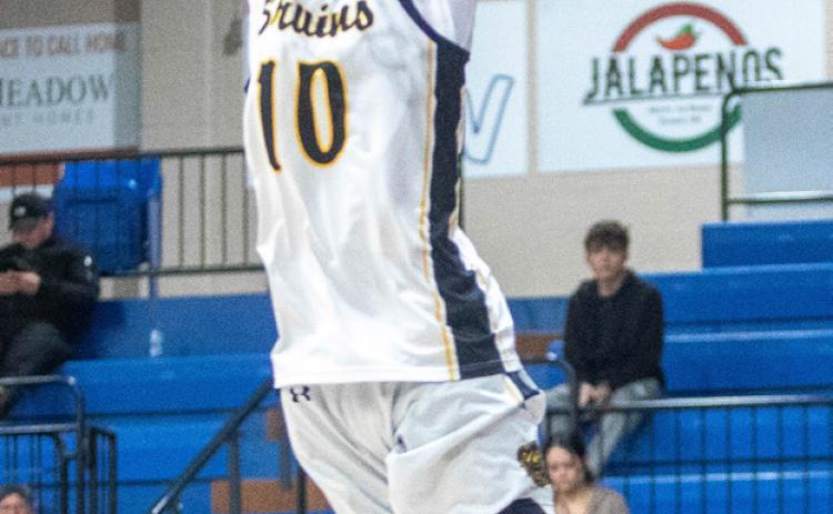 Caddo Bruin Jet Rose makes a slam dunk during the Bryan County Basketball Tournament championship game.