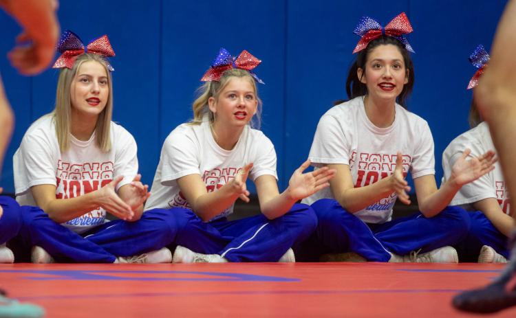 Durant High School cheerleaders from left, Shiloh Austin, Addison Couch and Jayda Fouse, were among cheerleaders cheering for Durant Lion wrestlers during a recent dual. Matt Swearengin | Durant Democrat