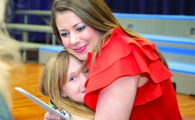 Northwest Heights Elementary STEM teacher Kasey Bennett was named the Durant School District’s Teacher of the Year and she embraces a student after the announcement was made Jan. 31. Matt Swearengin | Durant Democrat