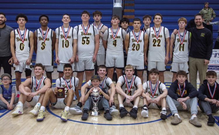 The Caddo Bruins pose after after winning the Bryan County Basketball Tournament championship game Jan. 23 at Bloomer Sullivan Arena. The Bruins defeated Colbert 75-58. See game story on sports page 8.