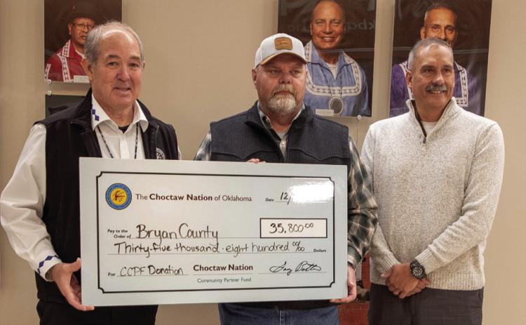 The Choctaw Nation has contributed $35,800 to Bryan County this year as part of the tribe’s Community Partnership Fund and ceremonial checks were presented last week at the Choctaw Headquarters. From left, Choctaw Tribal Council member for District 9 James Dry, District 2 Bryan County Commissioner Justin Boone and Choctaw Assistant Chief Chief Jack Austin Jr. Matt Swearengin | Durant Democrat