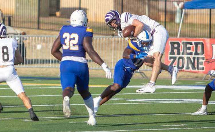 Southeastern football player Tony Hamilton lunges for a Ouachita Baptist player after he caught a pass. Also shown are Prince Dweh and Kole McKnight. Matt Swearengin | Durant Democrat