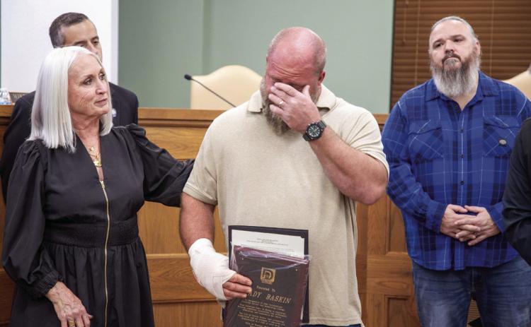 Brady Baskin reacts when speaking during a Durant City Council meeting where he was honored for his service to find and recover Clara Robinson, who along with her father, Will Robinson died during a Christmas Eve 2024 car accident. Also shown are City Manager Pam Polk, Vice Mayor Mike Simulescu and Council Member Humphrey Miller. Matt Swearengin | Durant Democrat
