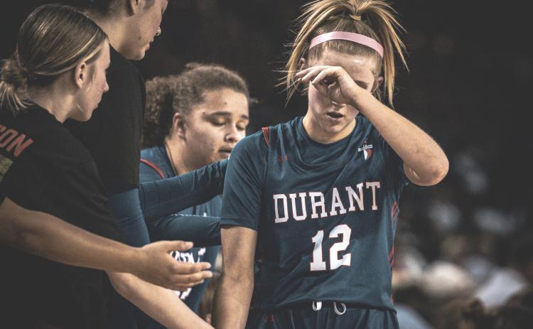 Durant Lady Lion basketball players react during the state opener. Among those shown is Emma Green. KBE Photography | Kirby Eldenburg