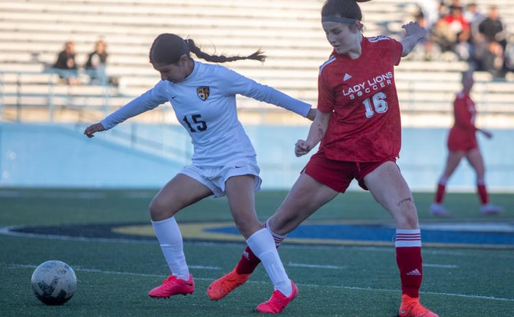Matt Swearengin | Durant Democrat Lady Lion Aubree Wise and a Madill Lady Wildcat go after the ball in a recent game.