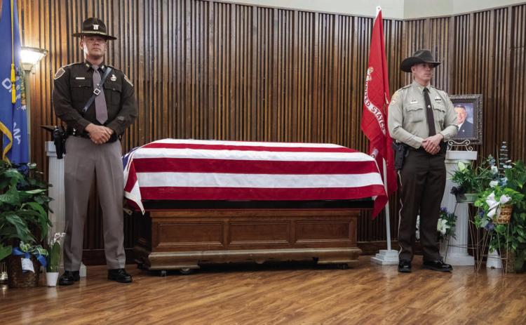 Oklahoma Highway Patrol Trooper Robby Keeling, left, and Bryan County Sheri’s Deputy Austin Murray stand watch Tuesday morning over Bryan County Sheri Johnny Christian’s casket at Holmes-Coey-Murray Funeral Home. Sheri Christian passed away March 28 and his celebration of life service was Wednesday at the Choctaw Event Center. Matt Swearengin | Durant Democrat
