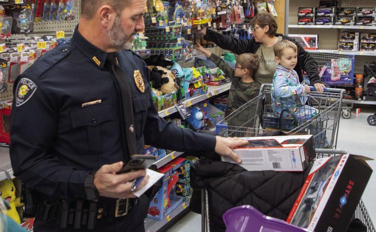 Durant Police Chaplain Brent Smith, who passed away last week, is shown helping the Durant Police Department’s Shop with a Cop in December 2024. Matt Swearengin | Democrat file photo