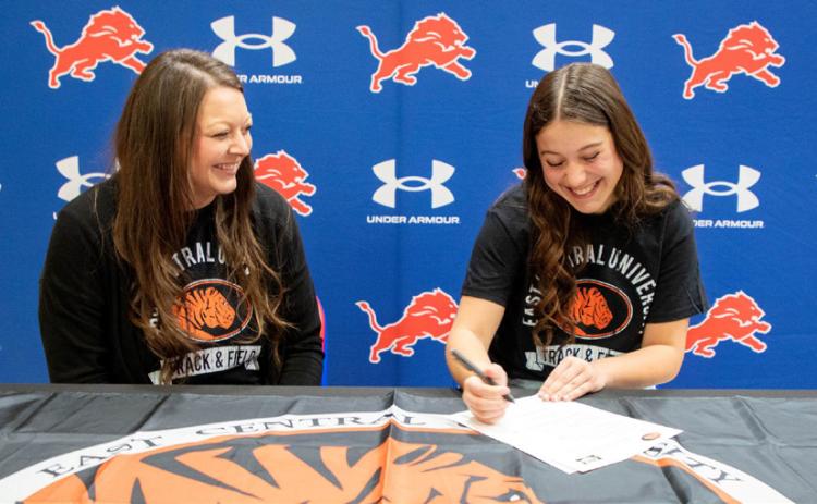 Lady Lion Macee Hall signed a track and field scholarship with East Central University. She is shown with her sister Halee Grimes. Matt Swearengin | Durant Democrat