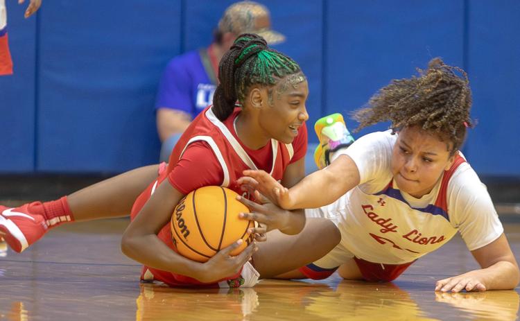 Lady Lion Abrianna Freeman and a Tulsa East Central player tussle over the ball. Matt Swearengin | Durant Democrat