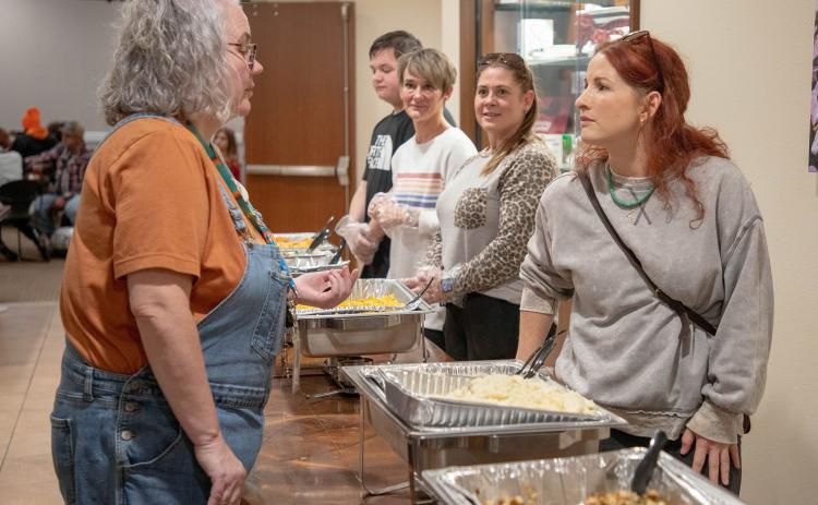 Robbee Tonubbee, left, director of the Donald W. Reynolds Community Center &amp; Library, is shown at the recent Thankful dinner where meals were served to people in the community. Matt Swearengin | Durant Democrat