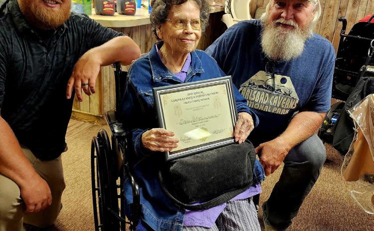 Mary Perkins, 99, received an award during the Gardner family reunion for being the oldest living family member. She is shown with Tyler Gardner and David Gardner.