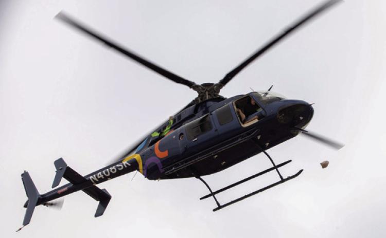 A turkey is dropped from a helicopter at Durant High School to benefit the school’s backpack program. Matt Swearengin | Durant Democrat