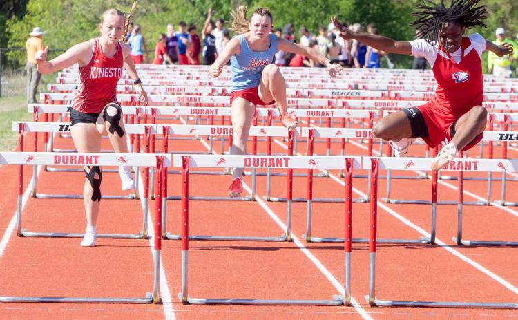 Durant Lady Lion Iyana Wilson, right, leaps over a hurdle during the Lion Track Meet. Matt Swearengin | Durant Democrat