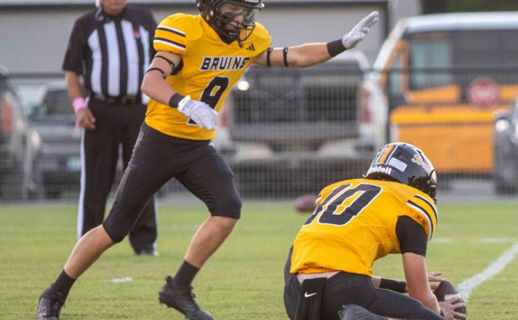Caddo Bruin Jake McKay is about to kick the extra point and Cale Wigington is holding the ball. Matt Swearengin | Durant Democrat