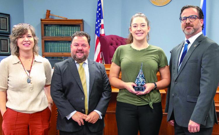 Bryan County Deputy Court Clerk Myranda Richmond, third from left, was presented with the 2025 Oklahoma Bar Association Family Law Section’s Courthouse Sta_ Member of the Year Award. Also shown are Court Clerk Stacey Canant, attorney Chris Jones and John Barbush, who is a member of the Bar Association’s Board of Governors. Matt Swearengin | Durant Democrat