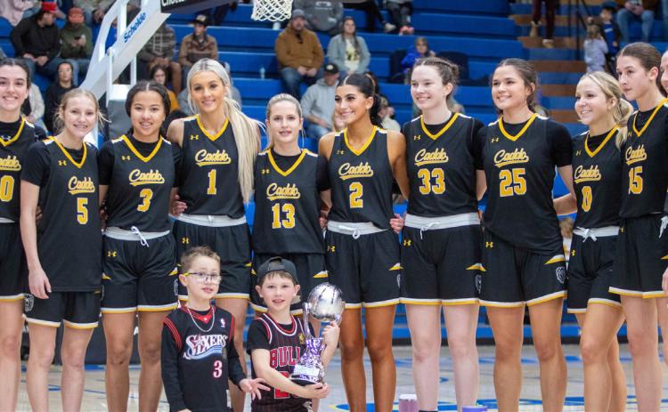The Caddo Lady Bruins basketball team poses after winning the Bryan County Tournament championship game with Calera Saturday night at the Bloomer Sullivan Arena. Matt Swearengin | Durant Democrat