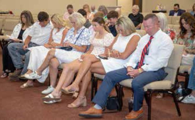 Durant Police Chief Jesse Petty and wife Courtney are among those praying during the Durant High School Senior Baccalaureate. The Petty’s daughter Kenzee is a graduate. Matt Swearengin | Durant Democrat
