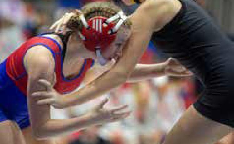 Lady Lion Addison Polk and Madill Lady Wildcat Andie Wallace wrestle during a dual last month in Durant. Matt Swearengin | Durant Democrat