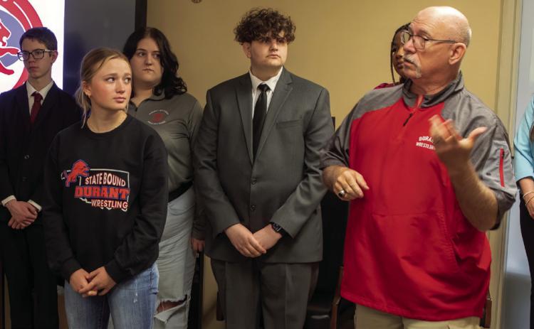 Durant High School wrestling head coach Jim Taylor talks about four-time wrestling state qualifier Addison Polk, left, during a Durant Board of Education meeting. Matt Swearengin | Durant Democrat