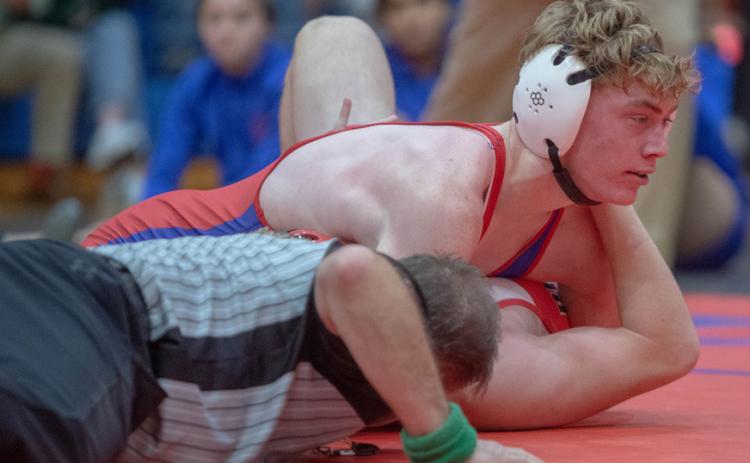 Lion Britton Trotter pins a Plainview wrestler.