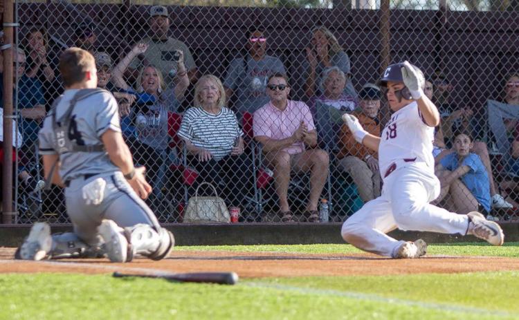 Colbert Leopard Eric Hokett slides into home plate during the home game with the Caddo Bruins and also shown is Bruin Bayler Black. Matt Swearengin | Durant Democrat