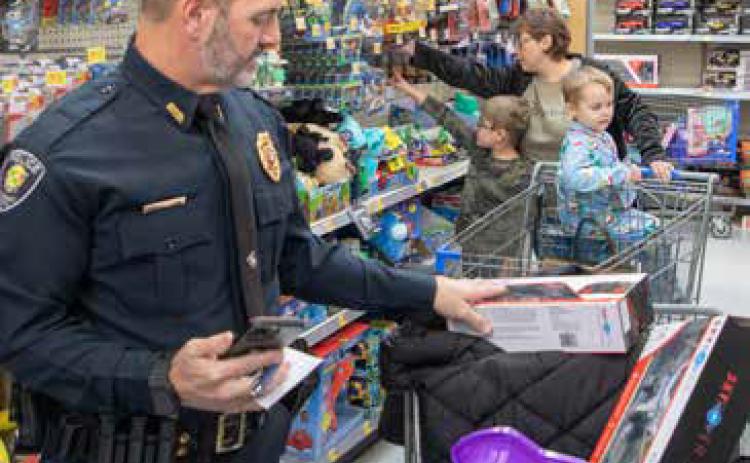 Police take children on shopping spree during Shop with a Cop